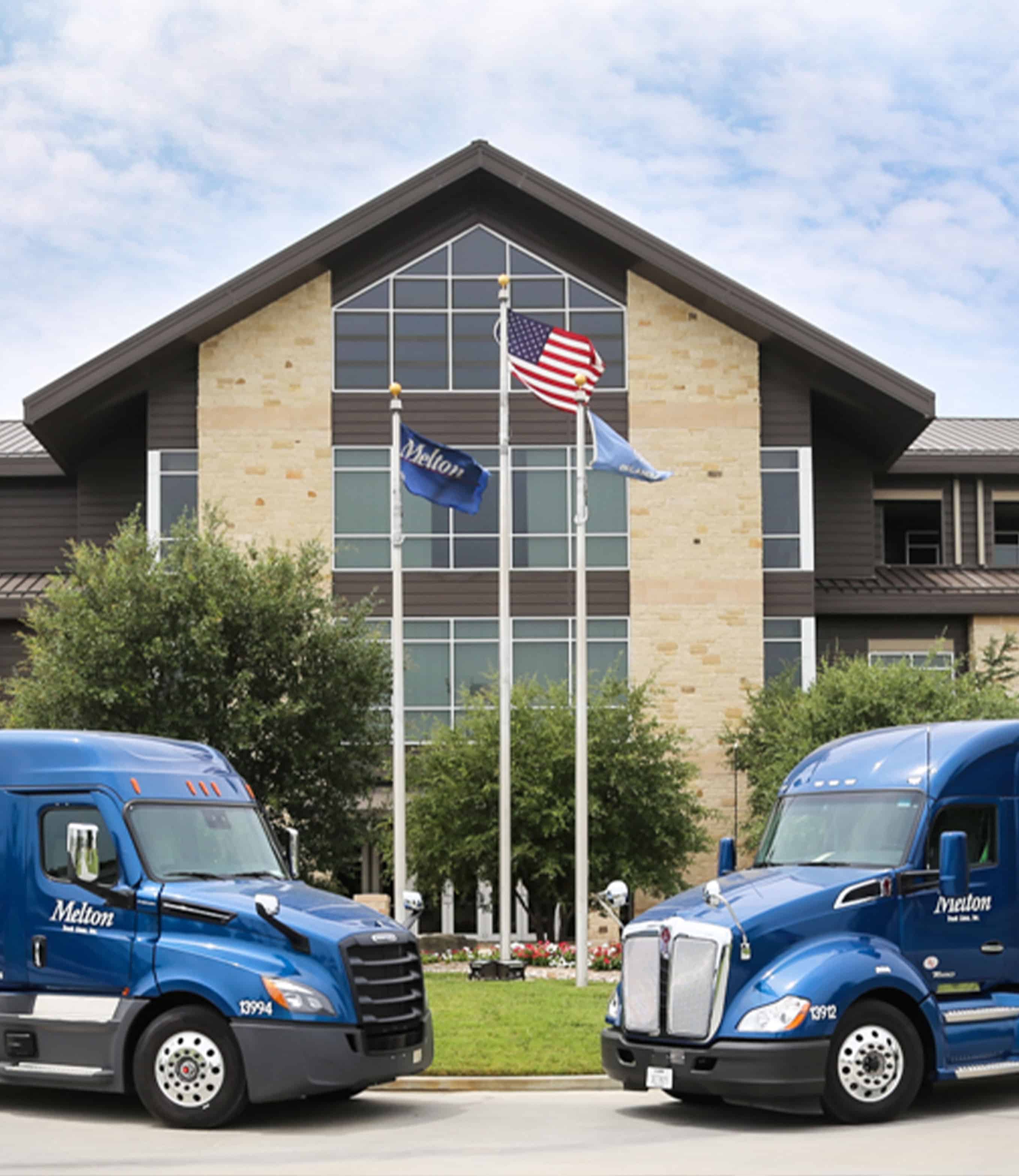 Two Melton trucks parked in front of the Melton Truck Lines headquarters.