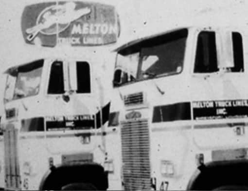 Black and white historical photo of two old Melton trucks