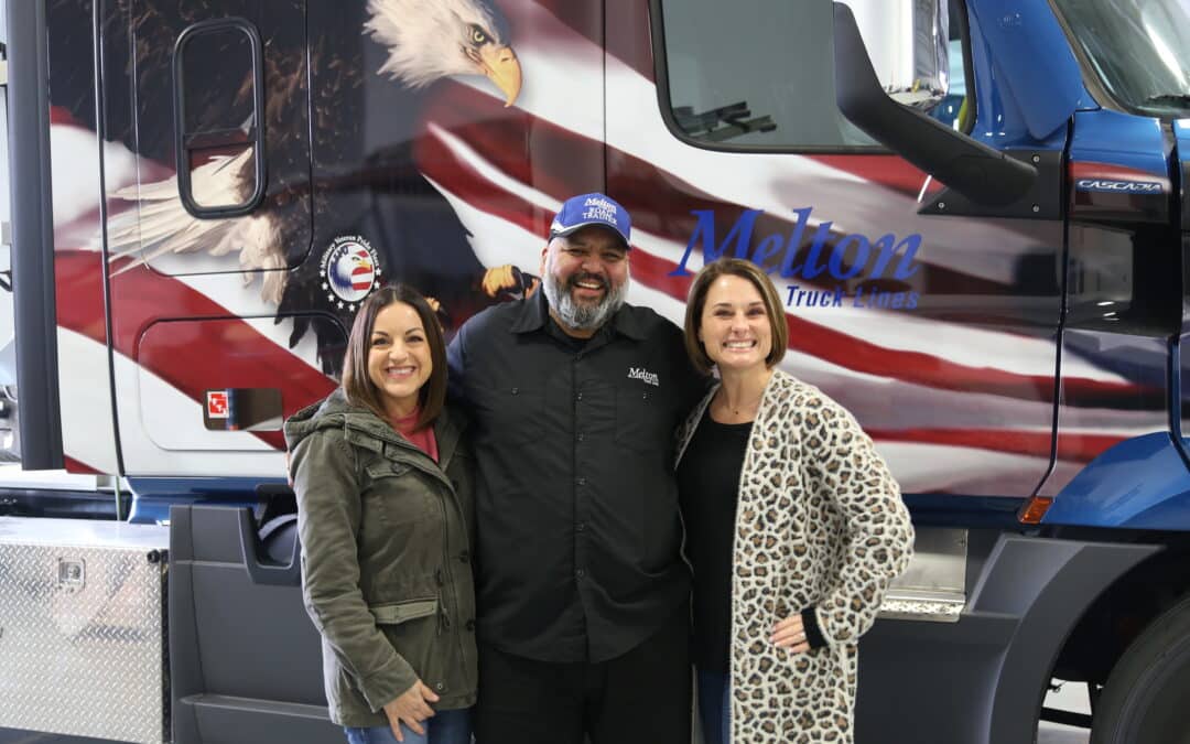 Veteran Flatbed Driver and 2 Melton Employees Standing in front of military wrapped flatbed truck