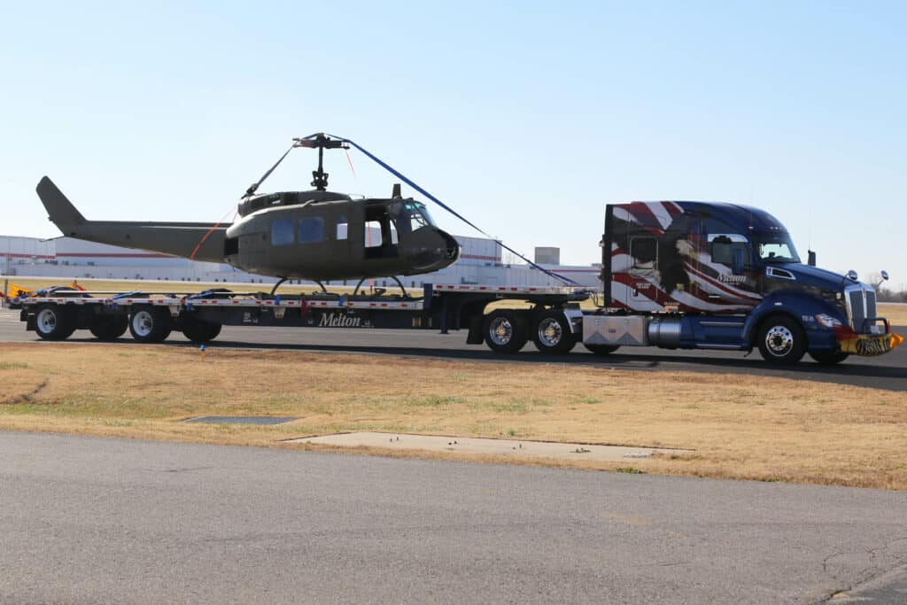 Helicopter on a Military Wrapped Melton Flatbed Truck