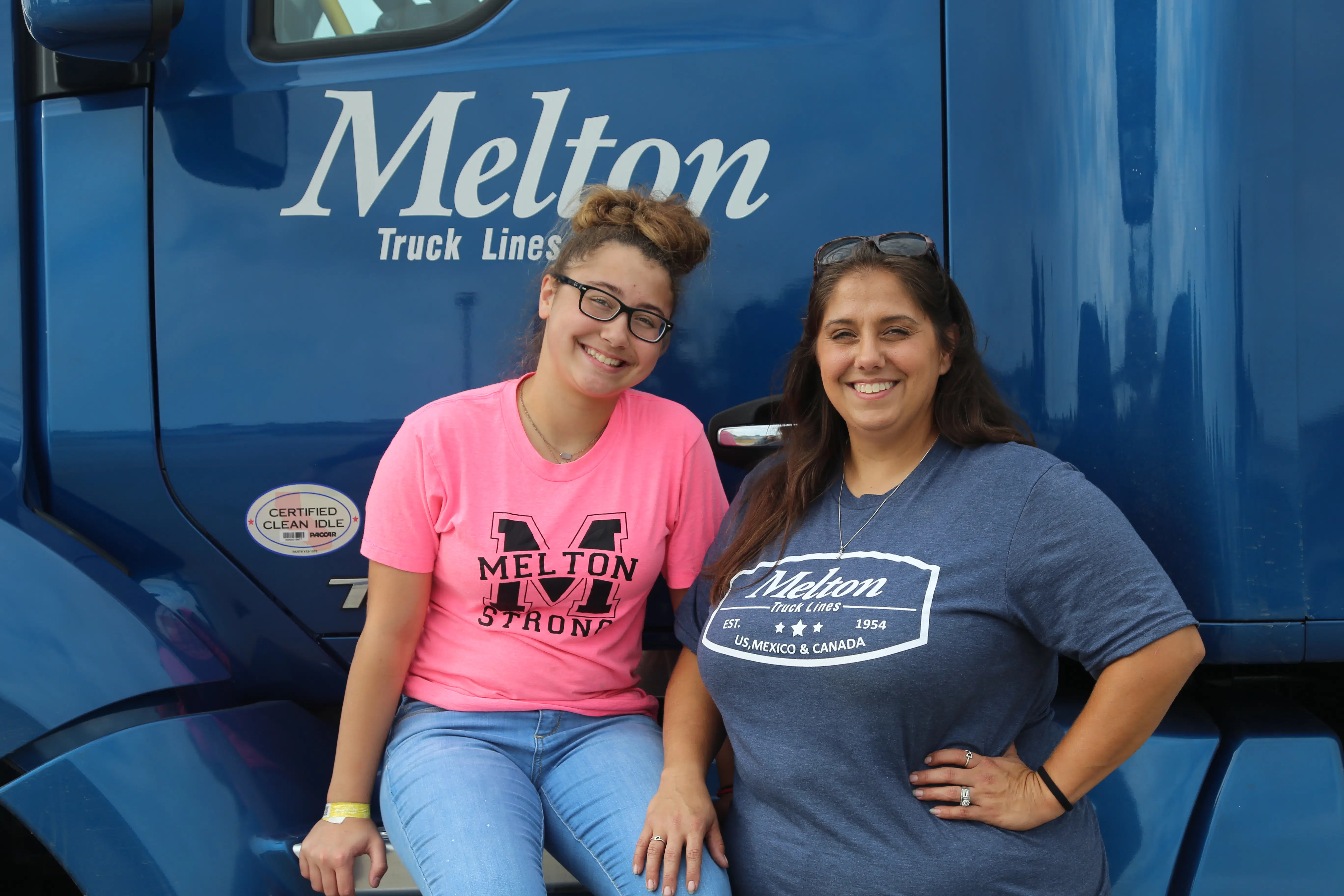Melton Driver and her daughter standing in front of Melton Flatbed truck