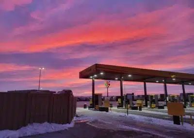 A cloudy pink and red sunset over a Love's gas station sent in by a driver