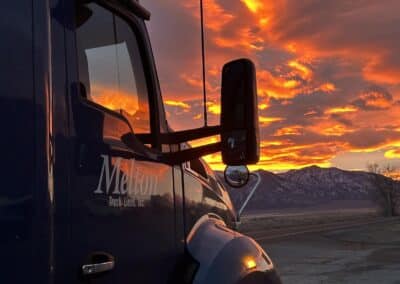 A warm sunrise in Utah with the side of a Melton truck.