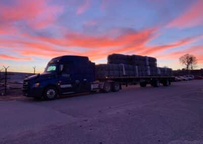A Melton truck against a pink and blue sunset