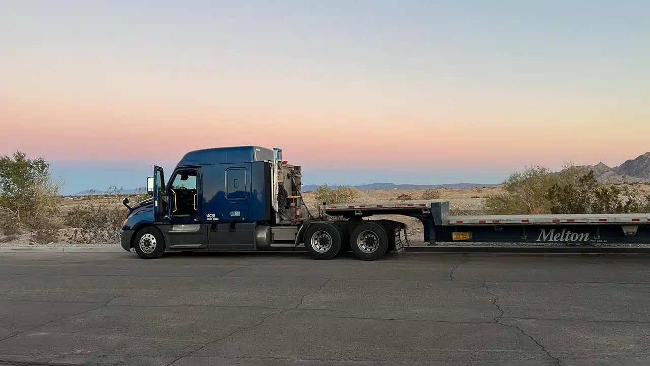 Melton flatbed driver stopped in front on the sunset