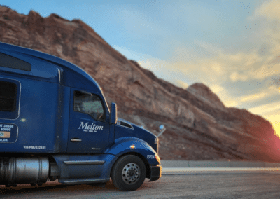 blue melton truck with sunset in background