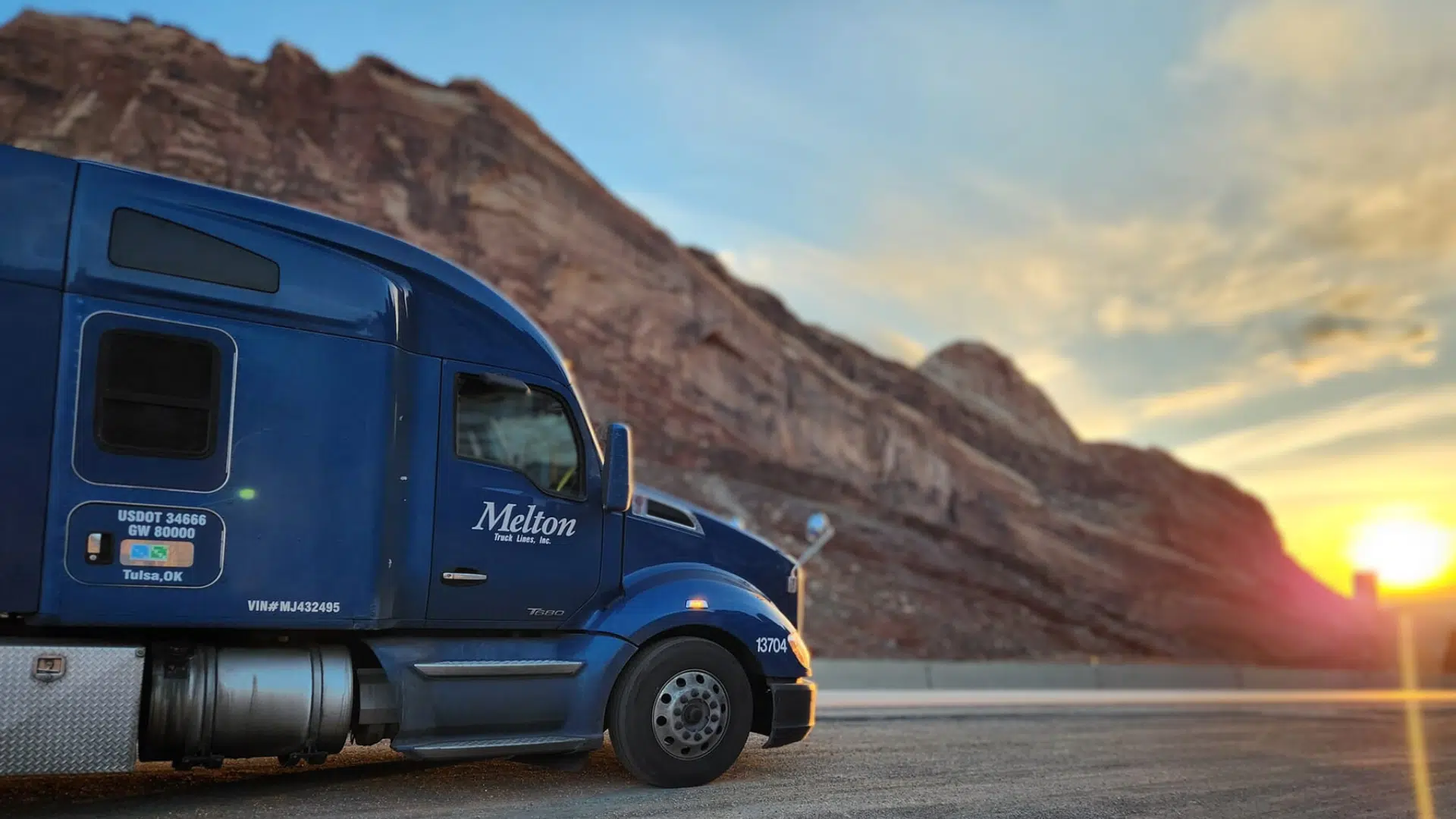 blue melton truck with sunset in background