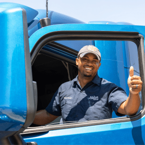 Melton driver holding up a thumbs up while getting into his truck