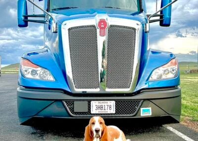 A beagle standing in front of a Melton truck