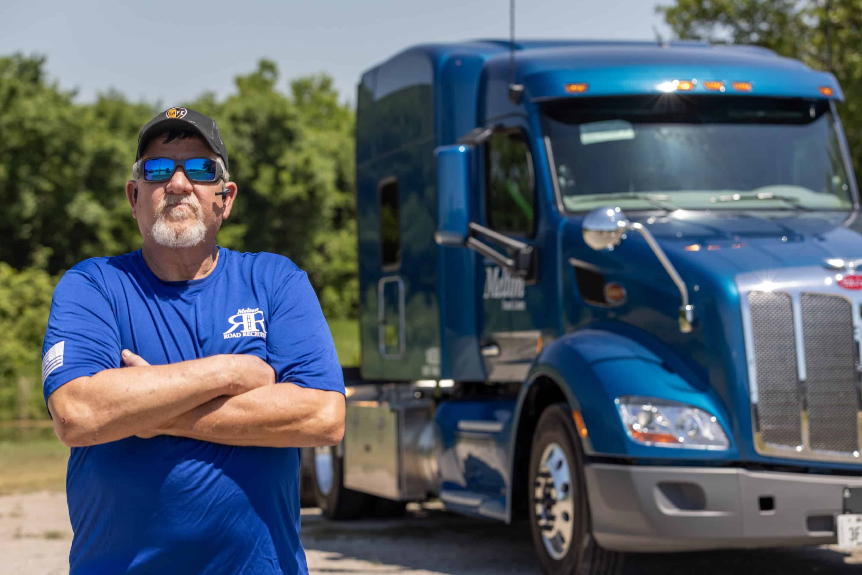 Two melton trucks backed into truck stop parking.