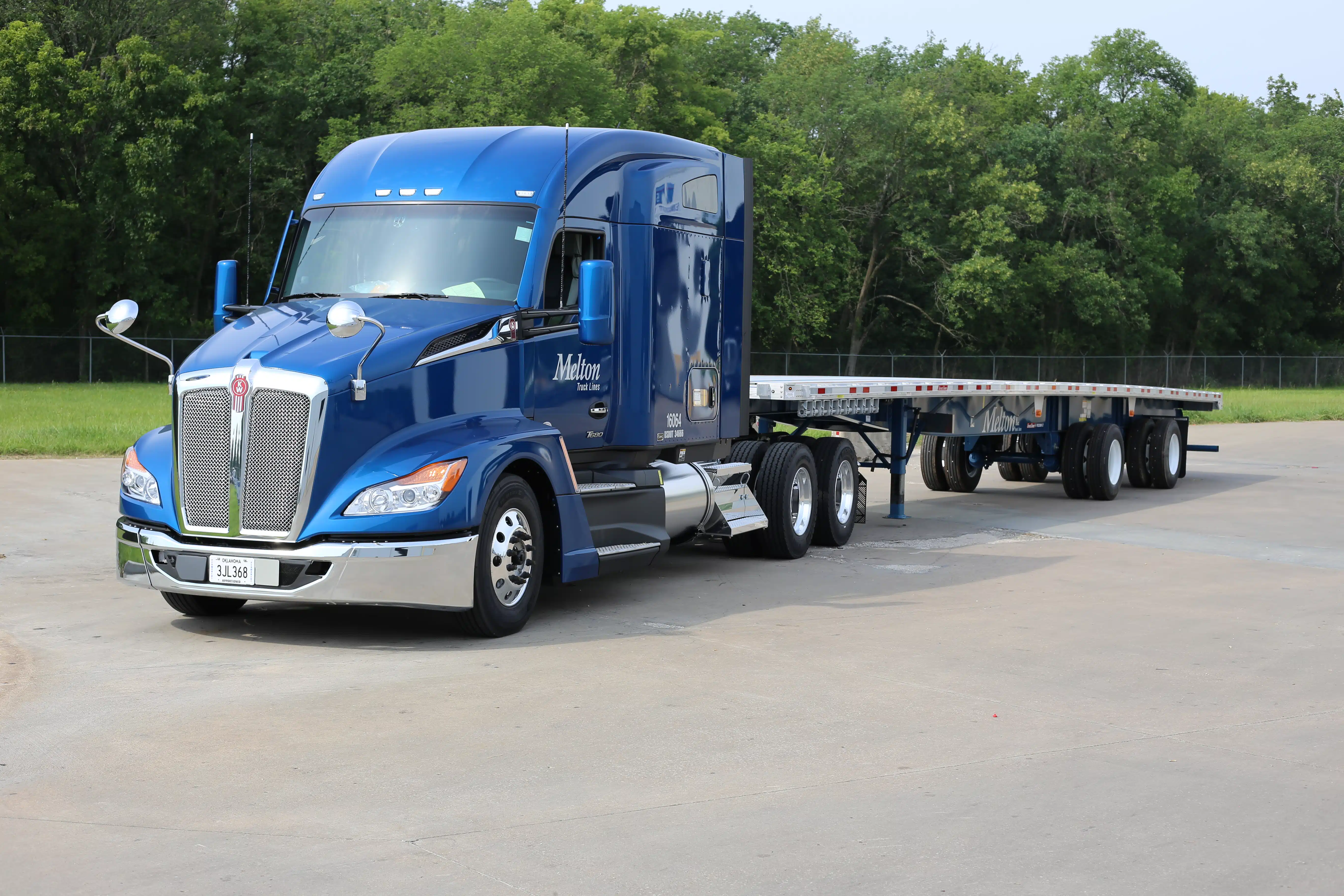 blue melton truck with flatbed trailer