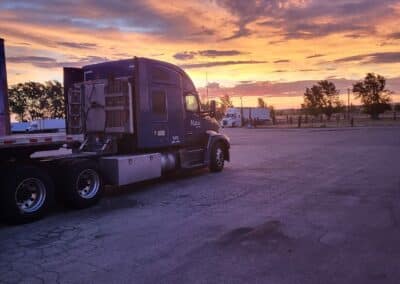 Melton truck parked facing a colorful sunset.