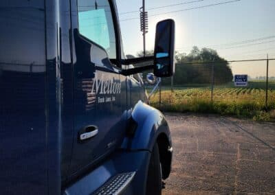 Side of a Melton truck facing the sunset