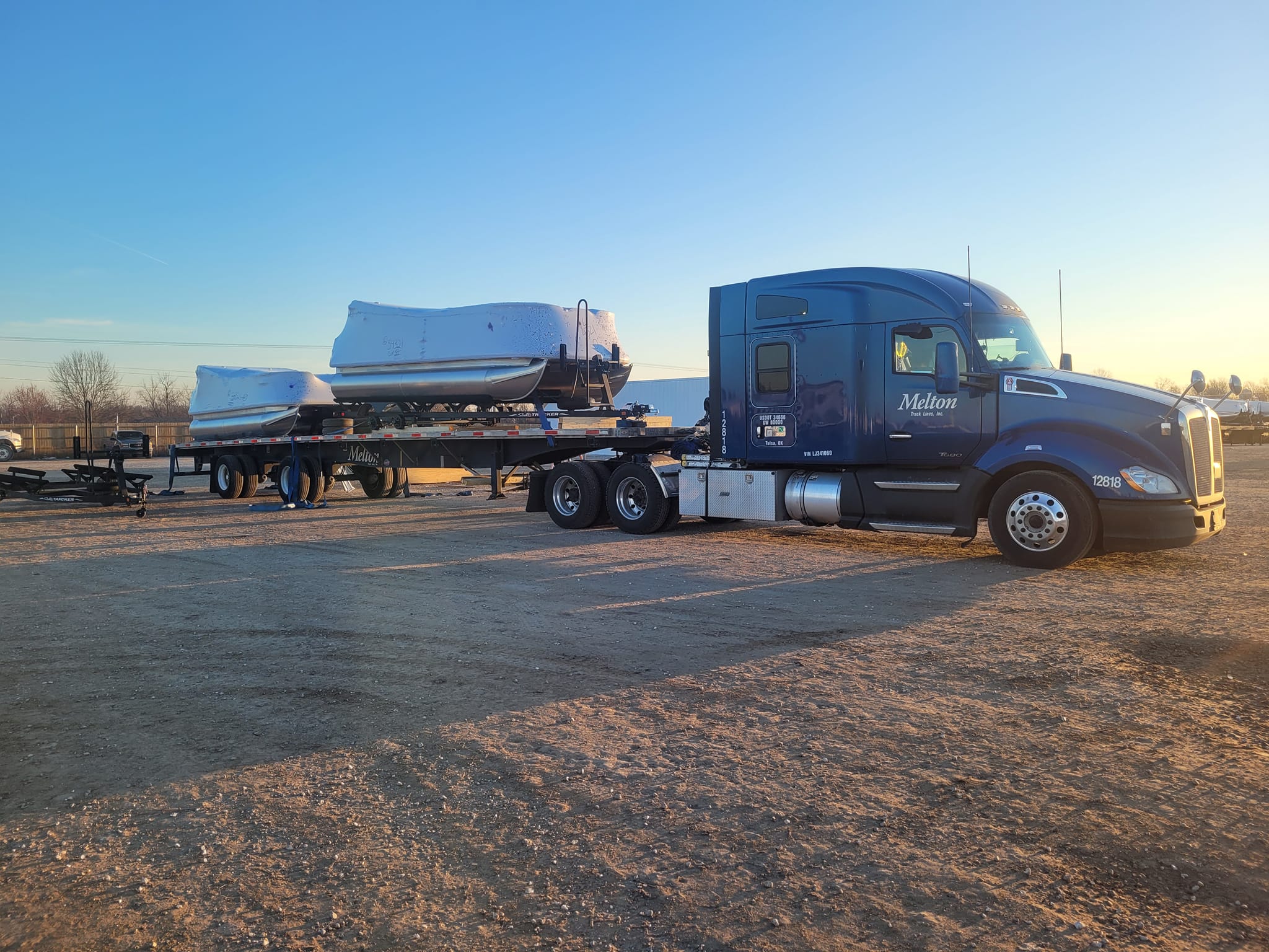 Melton flatbed truck hauling boats