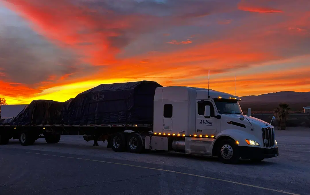 White Melton truck in front of a sunset