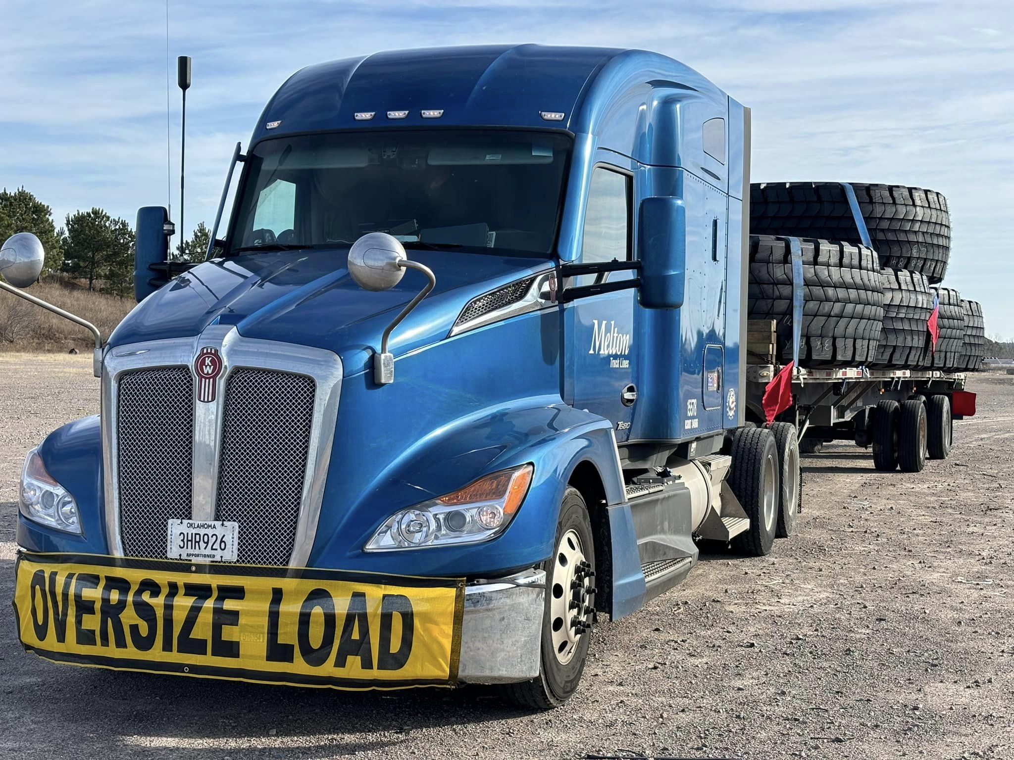 Overdimensional load of tires hauled by a Melton truck
