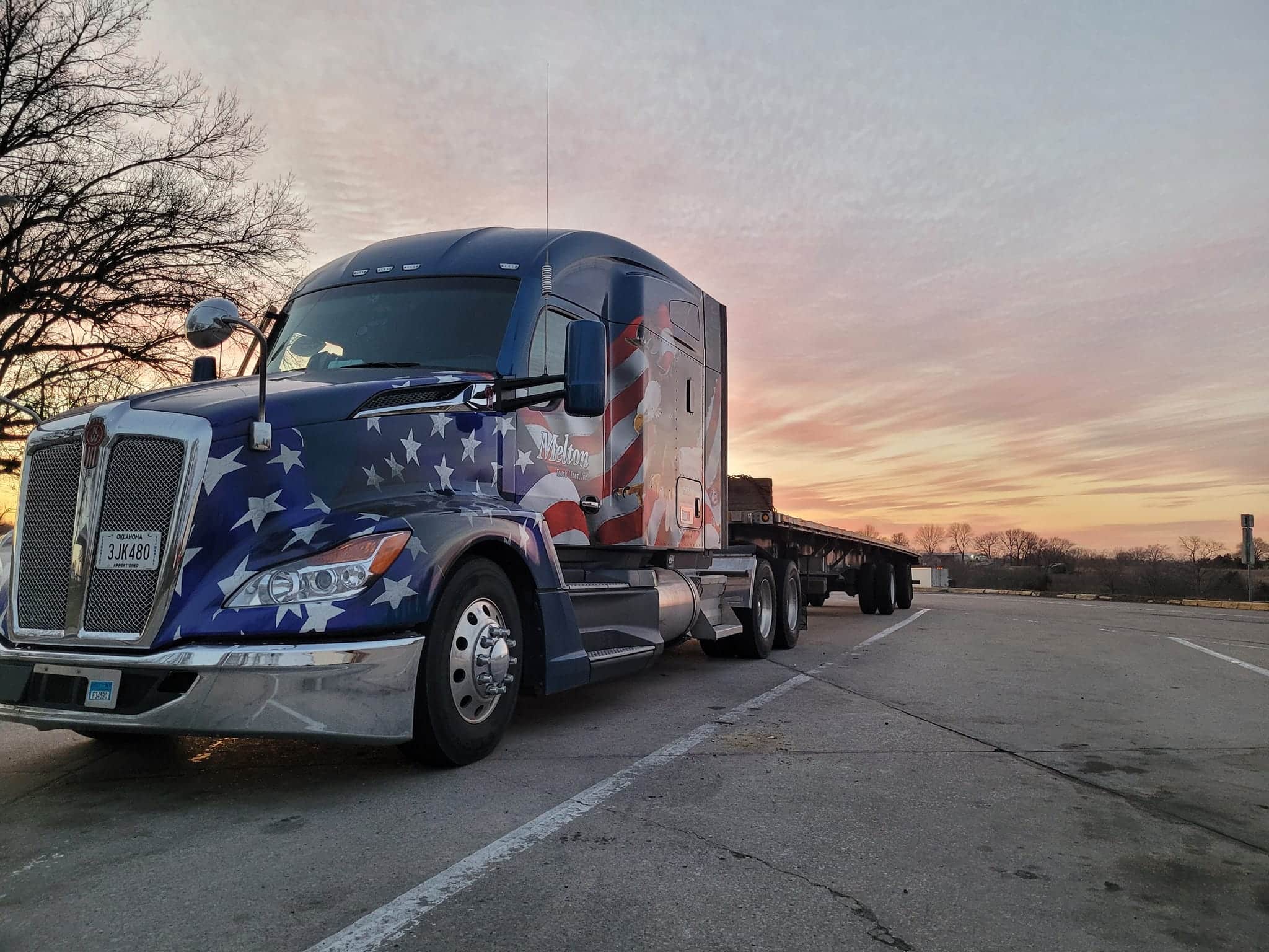 A veteran-wrapped Melton truck parked with a sunset behind it.