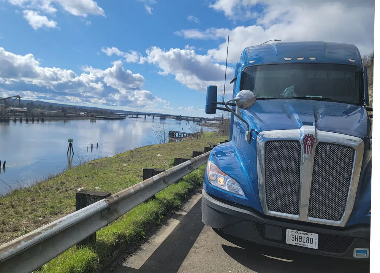Melton truck parked in front of a river