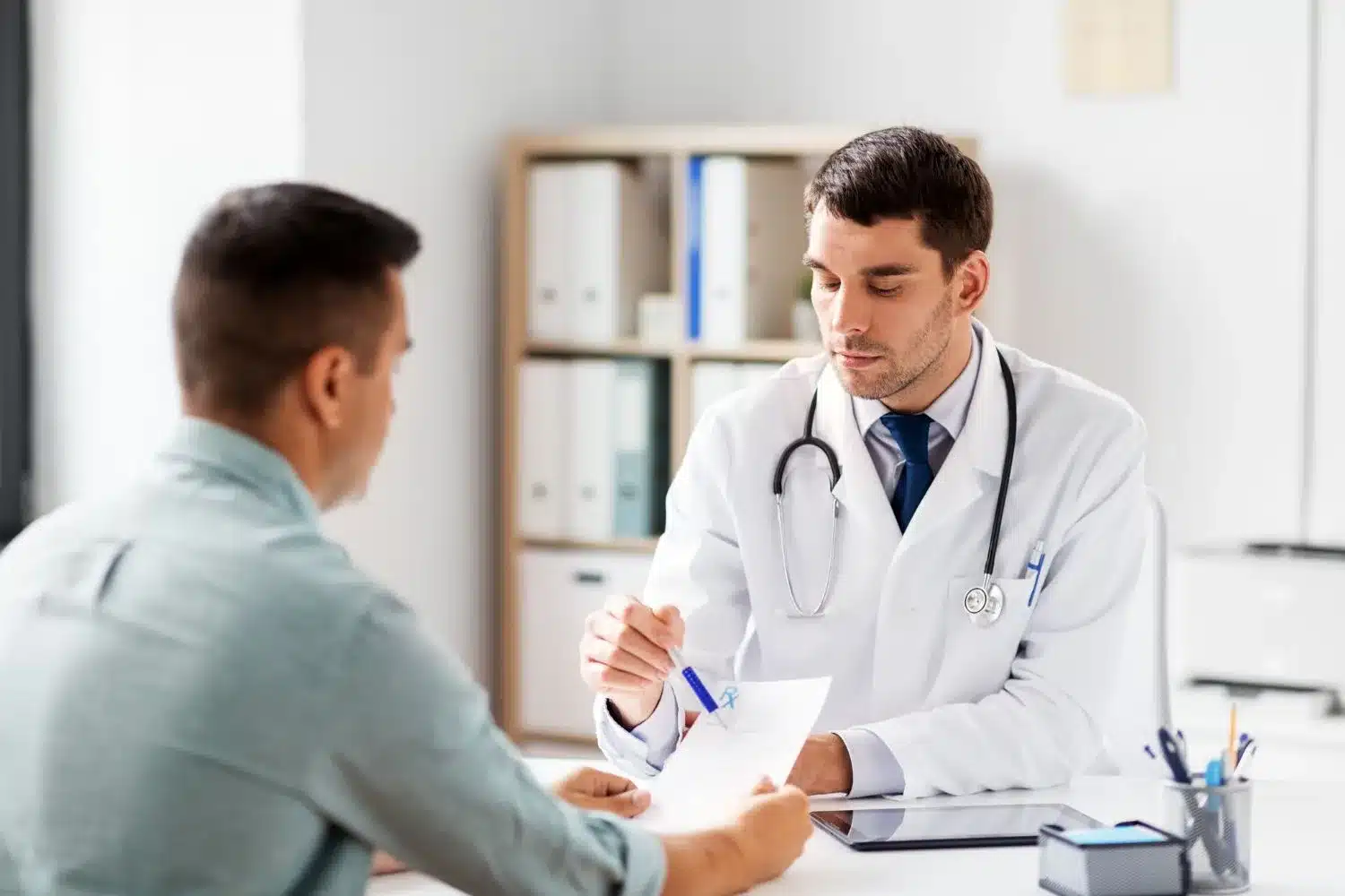 A doctor talking to a patient in his office