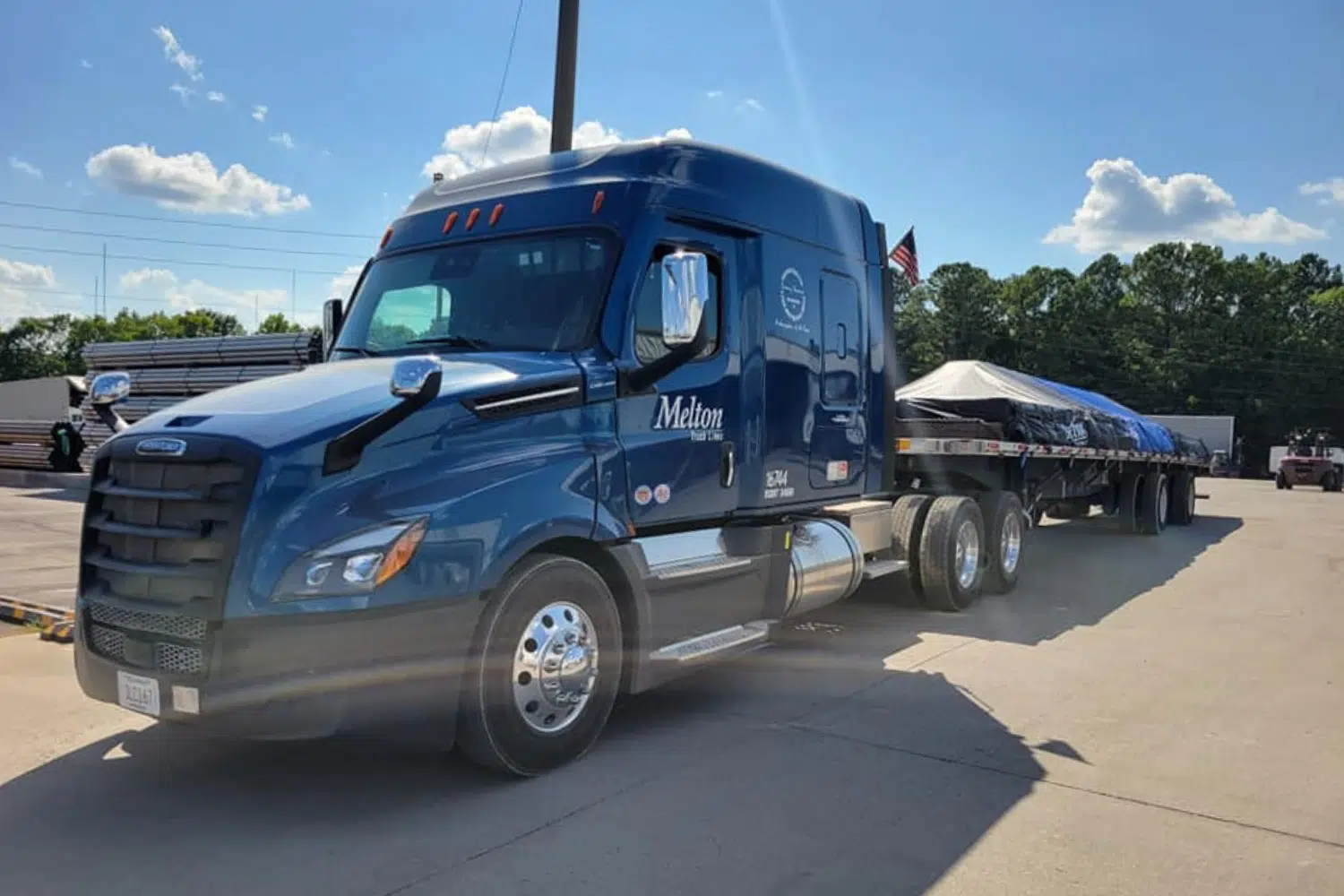 Melton truck parked with a tarped load