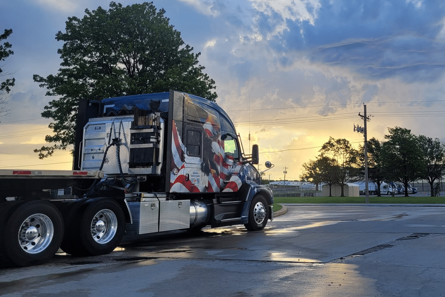 A Melton truck with a patriotic wrap in the sunset