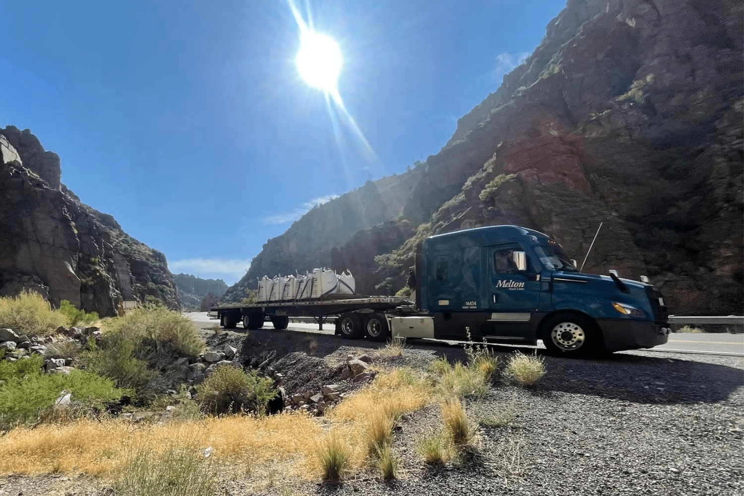 A Melton truck parked in a canyon.