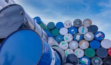 Blue, green, and white barrels full of hazardous substances.