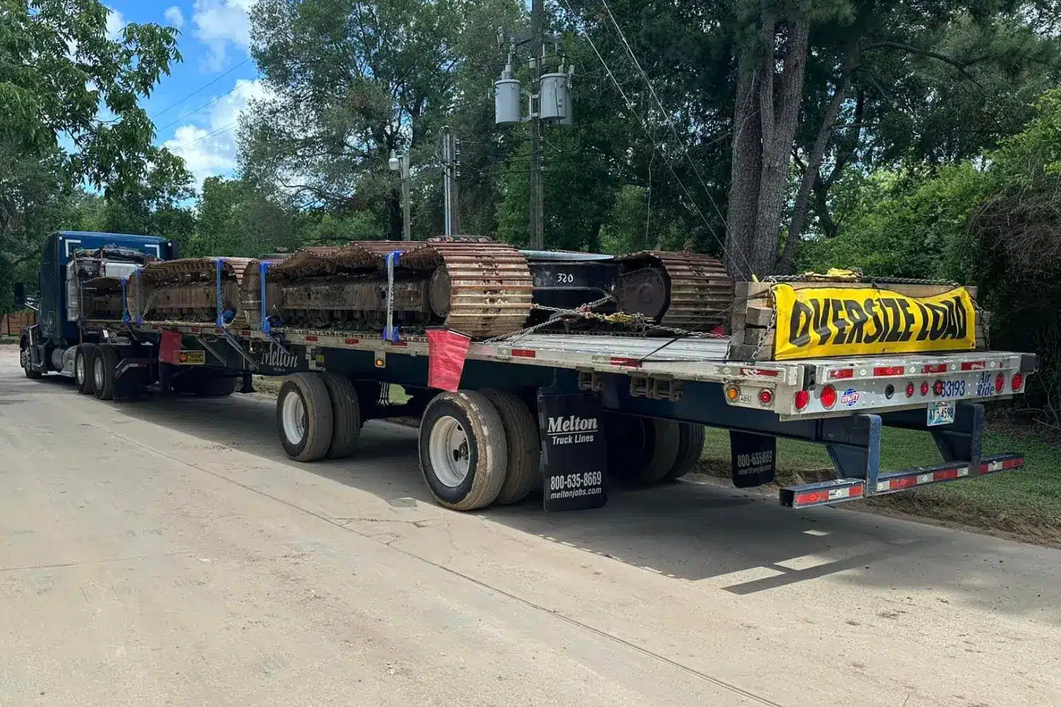 An over-dimensional load with a OD banner secured to a Melton Truck