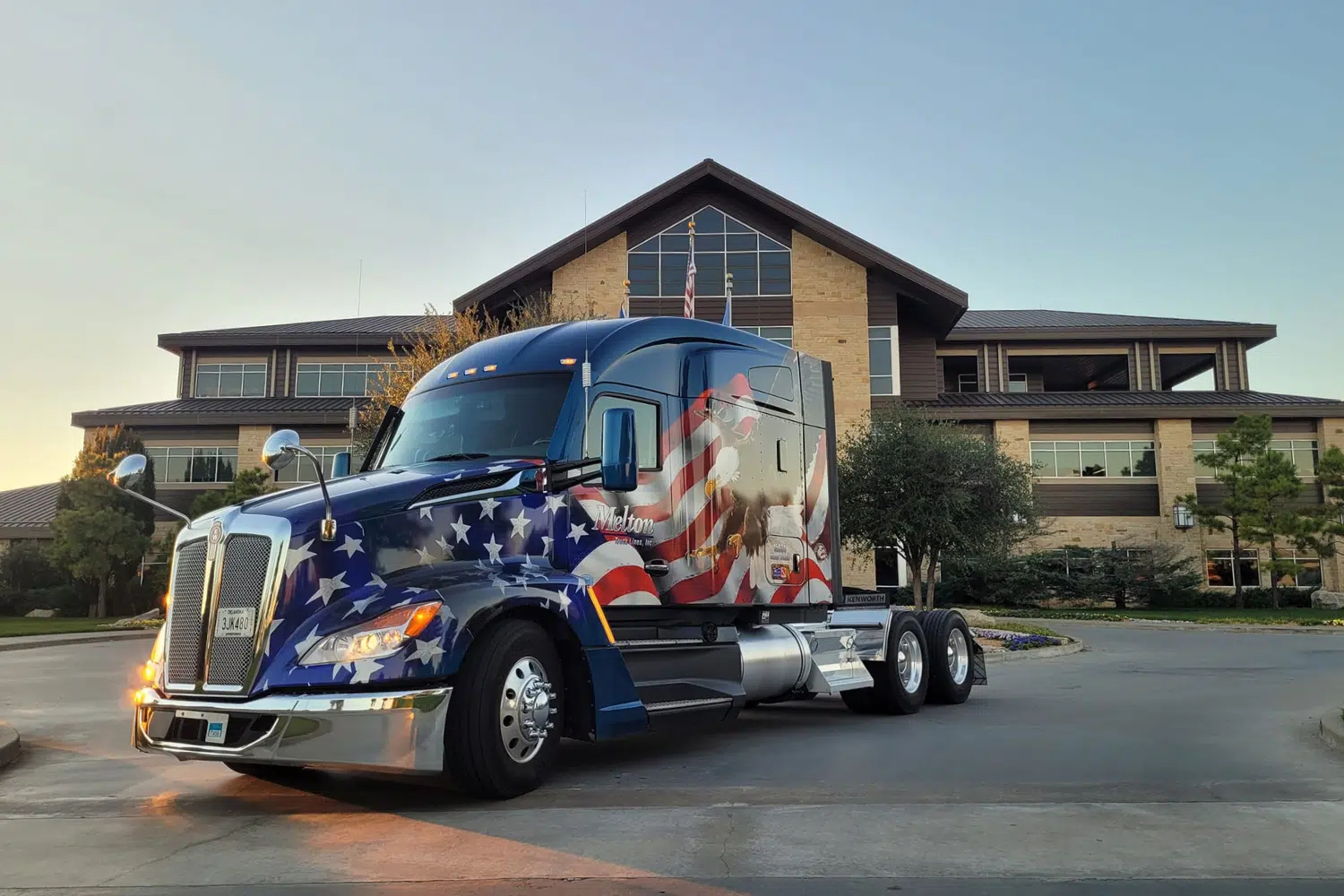 A patriotic Melton truck parked in front of the Melton Truck Lines terminal