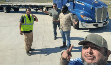 A Melton driver taking a selfie with other Melton employees