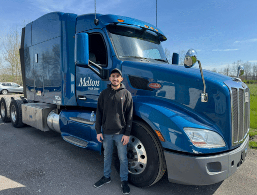 A new Melton driver standing in front of a semi truck