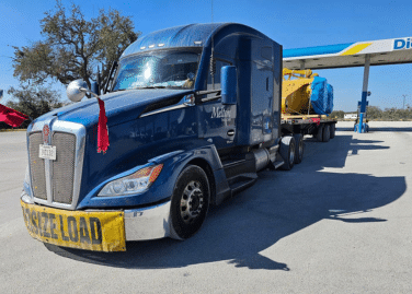 A Melton truck parked by a fuel island