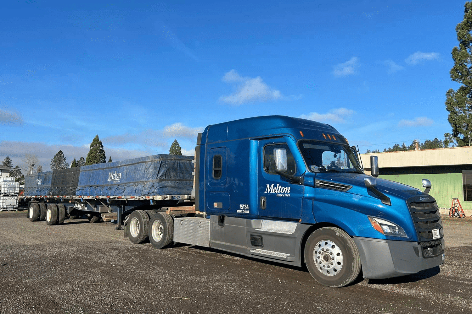 A Melton truck with a tarped load