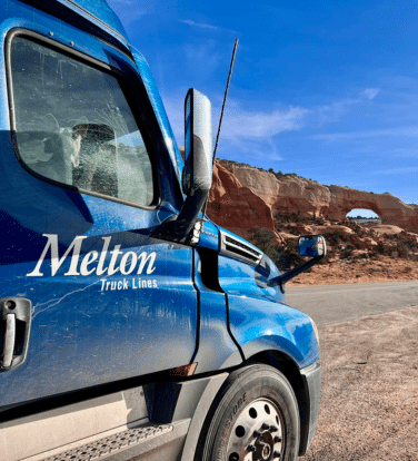 Melton truck parked in front of Wilsons Arch in Utah