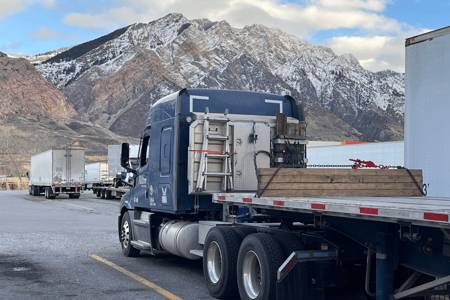 A Melton truck parked in front of a mountain