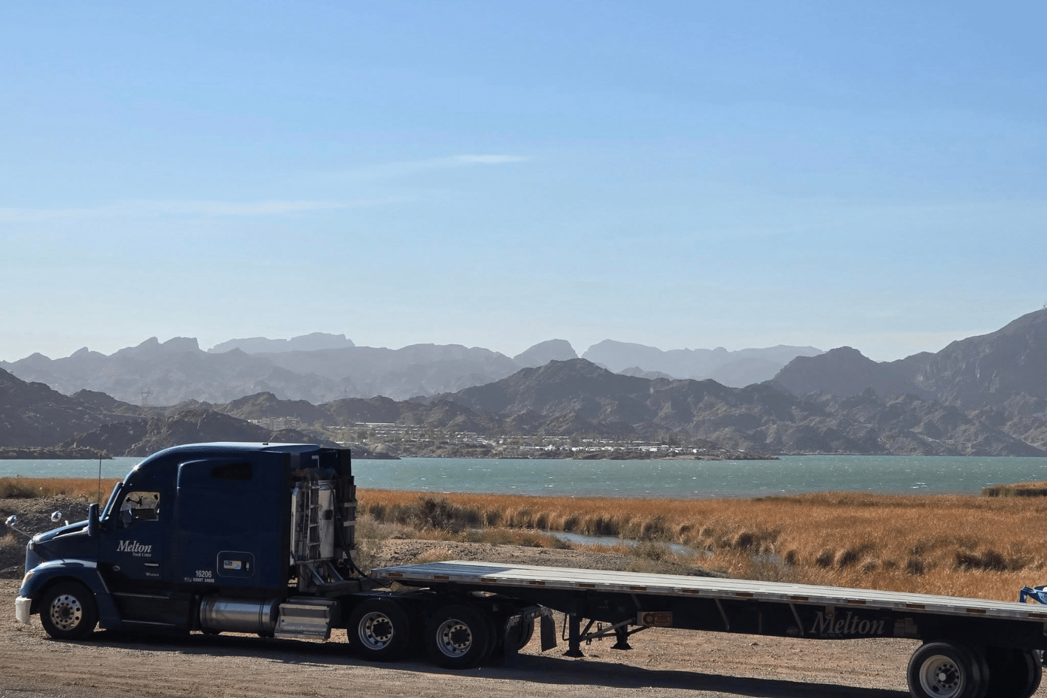 A Melton truck parked in front of the mountains