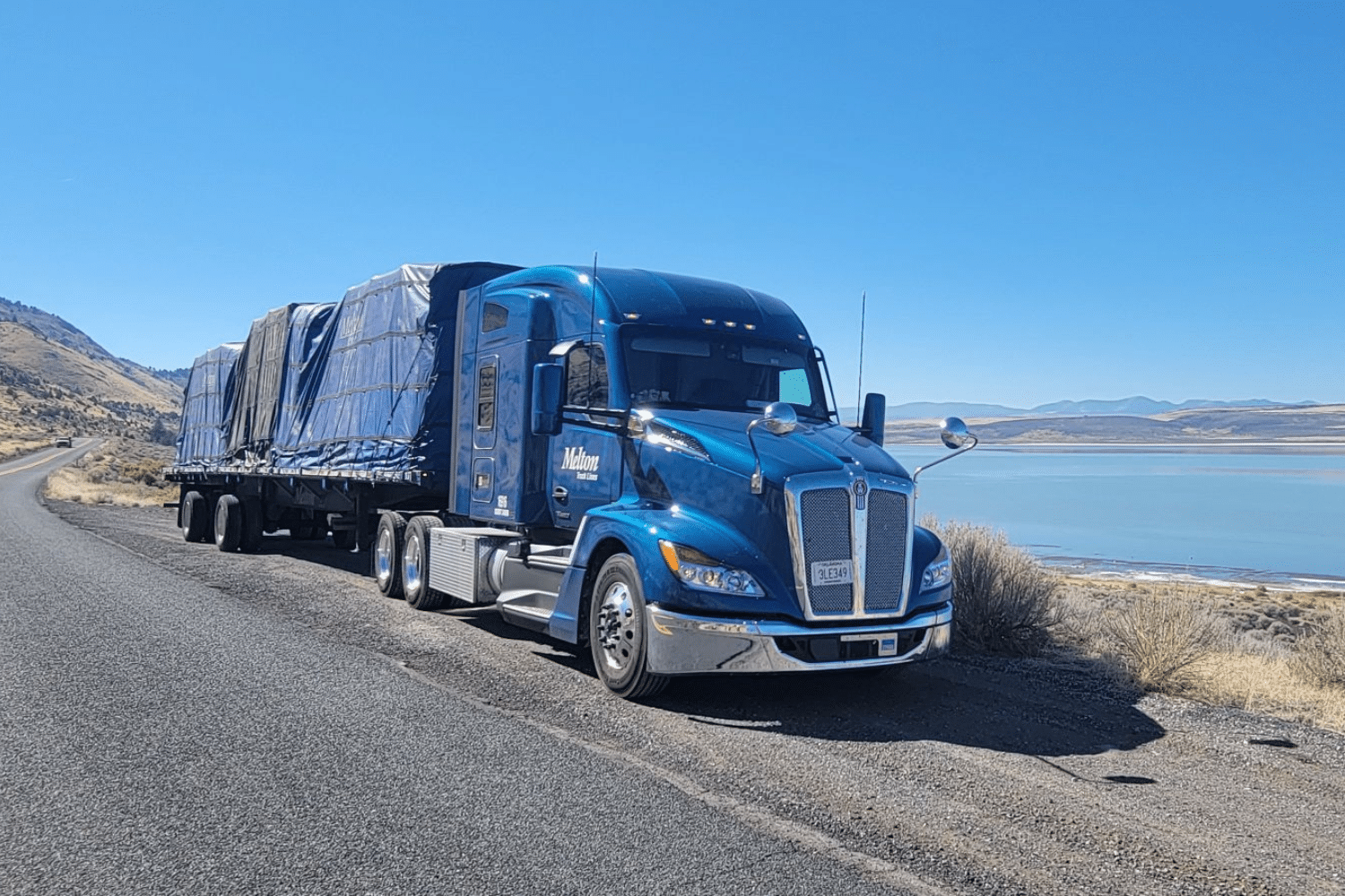 A Melton truck parked beside a lake